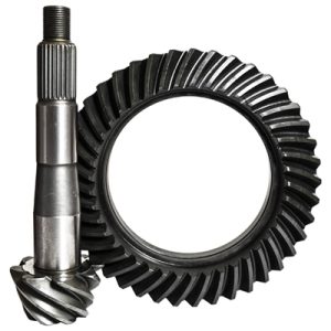 A metal ring gear and a pinion gear, key components in differentials, are displayed side by side on a white background. The pinion gear is cylindrical with spiral-cut teeth, whilst the ring gear is circular with angled teeth along the inner edge.