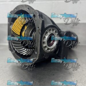 A close-up of a FORD FALCON BA SALOON & UTE REBUILT EXCHANGE DIFF with visible gears on a metal surface, set against a plain wall. The "Gearhead Diffs" watermark is repeated across the image.